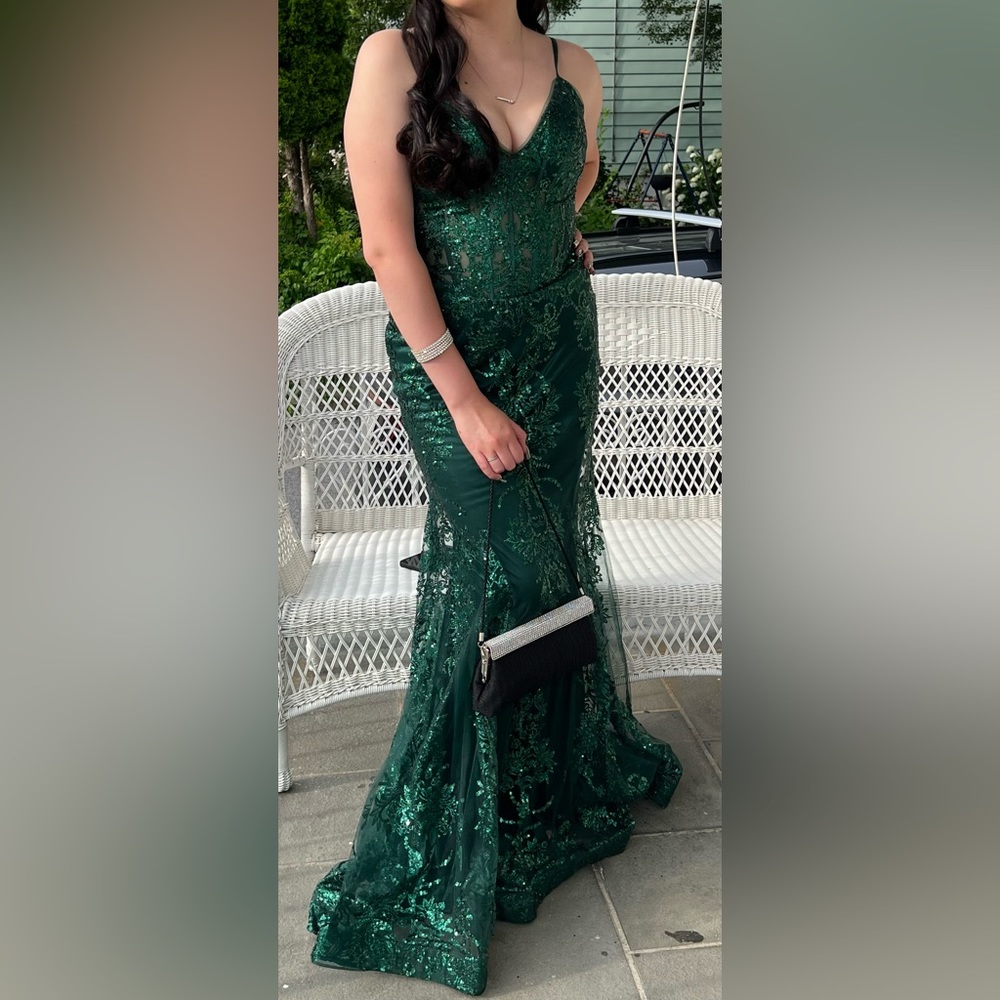 large emerald green prom dress with small tail in the back